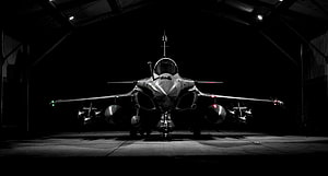 Dassault Rafale Fighter Jet Front View in Hangar with Weapons and Fuel Tanks HD wallpaper