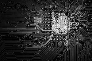 Black and White Close-Up of a Complex Printed Circuit Board with Integrated Chip HD wallpaper