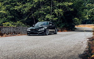 Black BMW M3 F80 Sedan Parked on a Winding Forest Road HD wallpaper