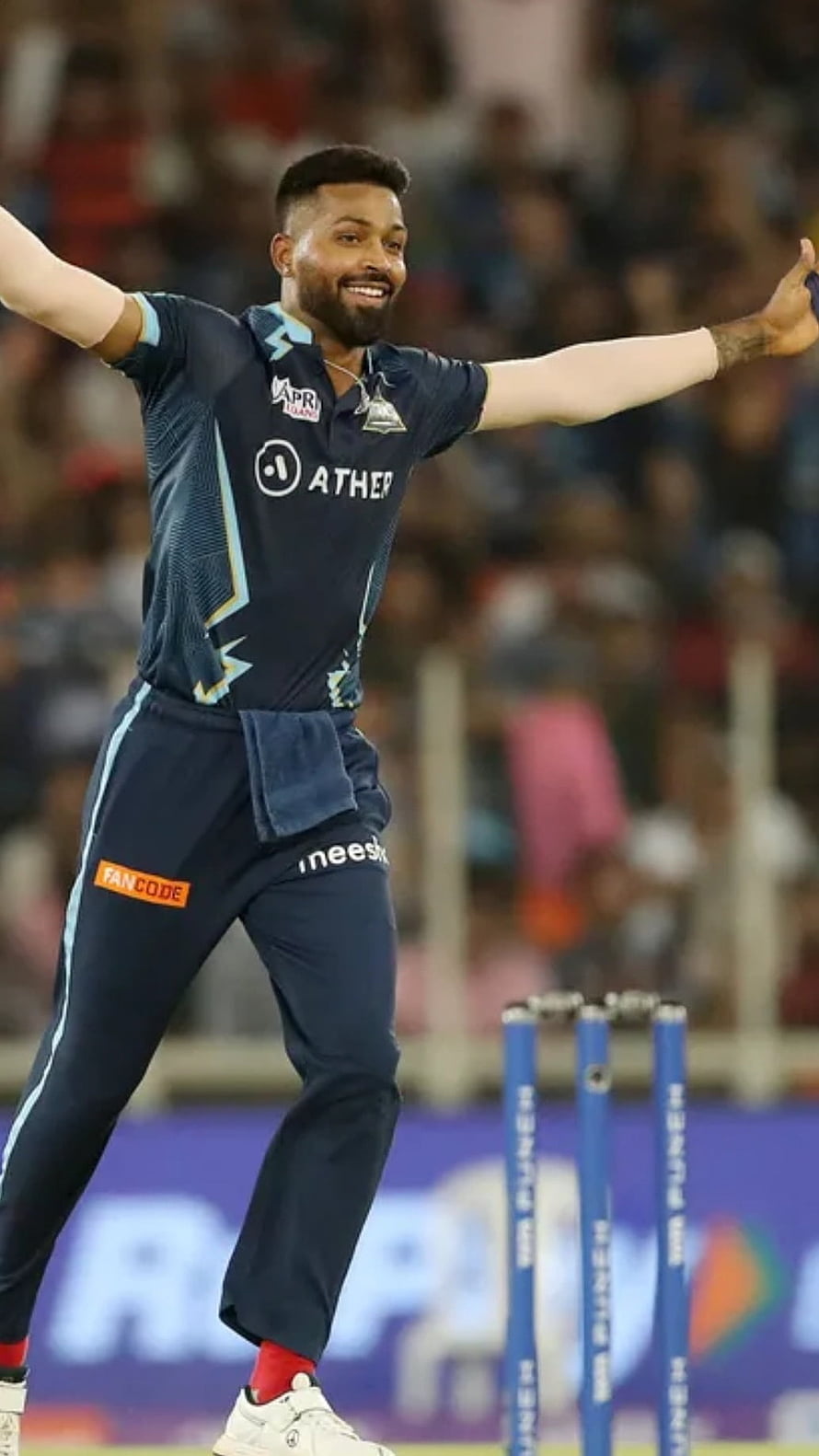 Gujarat Titans Cricketer Celebrating Victory at IPL Final with Arms Outstretched HD phone wallpaper