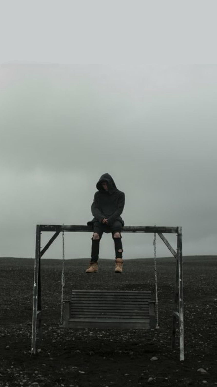 NF Sitting on a Swing Frame in a Desolate Landscape Under an Overcast Sky HD phone wallpaper