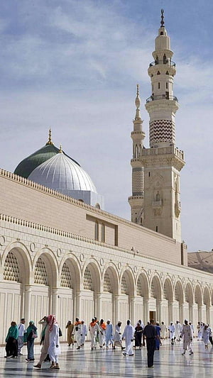 Grand Mosque Courtyard with Minarets and Green Dome Under Blue Sky HD phone wallpaper