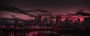Dramatic Red Tinted City Skyline at Night with Water Reflections HD wallpaper