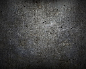 Dark scratched metal surface texture with industrial grunge and distressed finish HD wallpaper