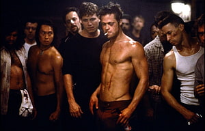 Brad Pitt shirtless in Fight Club with group of men in dimly lit room HD wallpaper