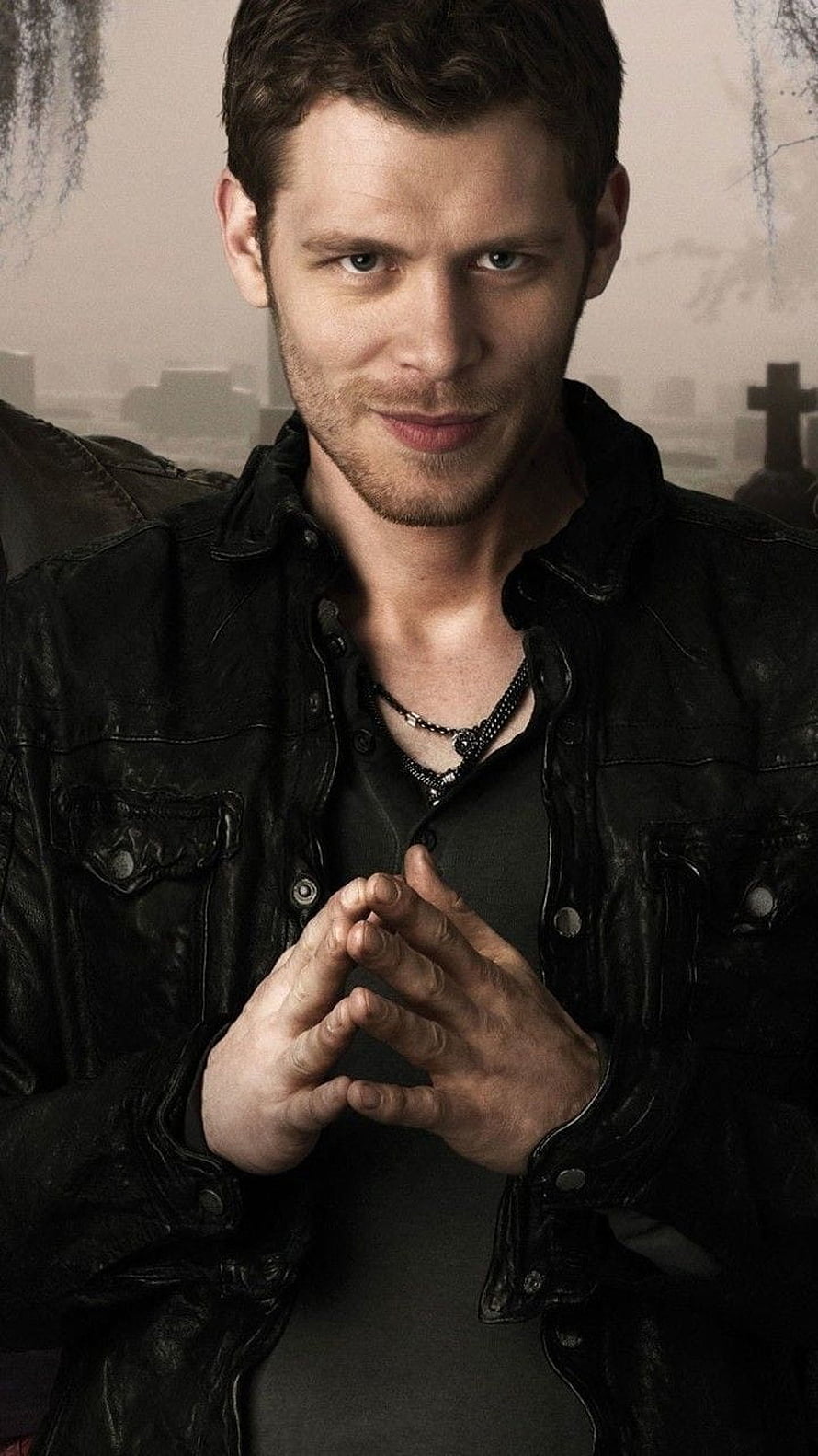Klaus Mikaelson from The Originals in a black leather jacket with a cemetery backdrop HD phone wallpaper