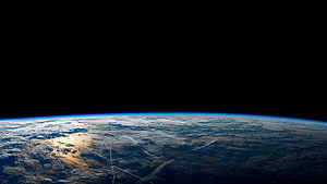 Earth Horizon From Orbit With Blue Atmosphere And Cloud Cover Against Black Space HD wallpaper