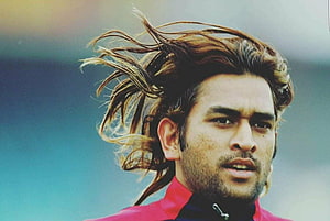 MS Dhoni Portrait With Long Flowing Hair And Intense Gaze HD wallpaper
