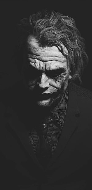 Heath Ledger as The Joker in a moody black and white portrait with dramatic low-key lighting HD phone wallpaper