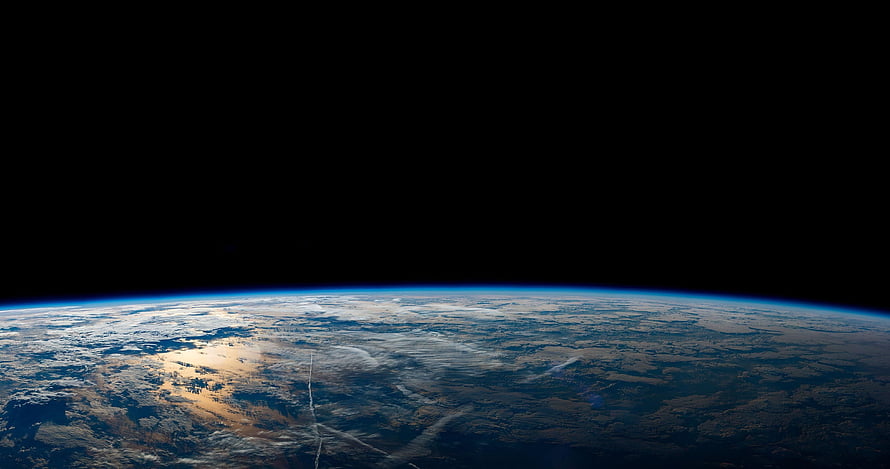 Planet Earth Curvature Viewed From Orbit With Atmospheric Glow Against Deep Space HD wallpaper