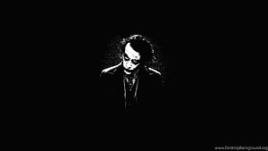 High Contrast Black and White Portrait of a Man in a Suit Against a Dark Background HD wallpaper