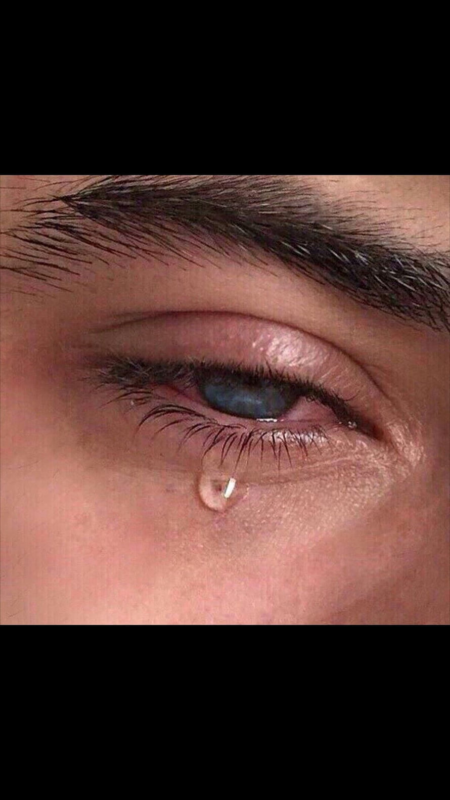 Close-up of a human eye with a single tear rolling down the cheek HD phone wallpaper