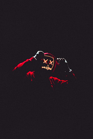 Anonymous Figure in Red Hood and Glowing X-Eye Mask Against Black Background HD phone wallpaper