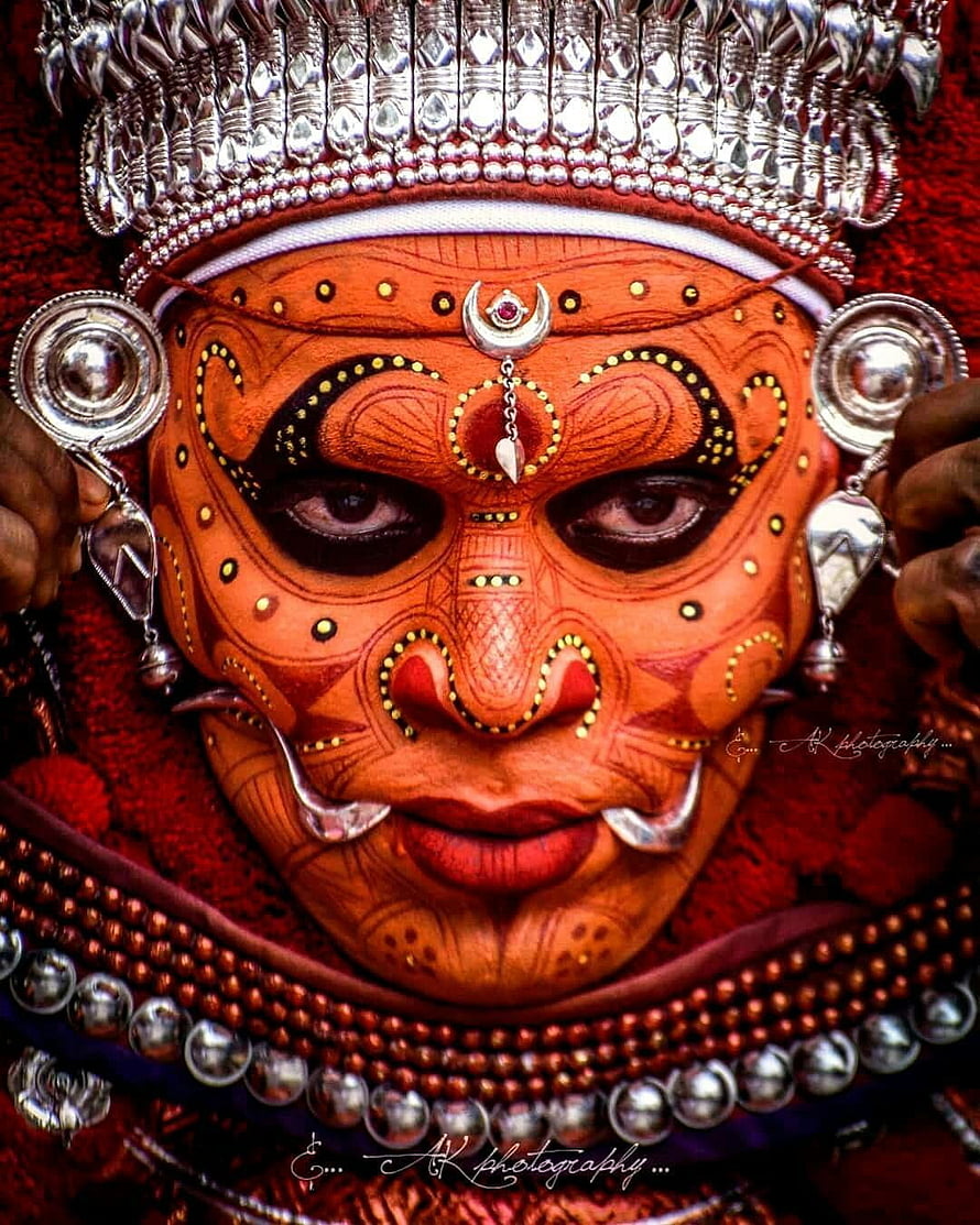 Traditional Theyyam Ritual Face Painting with Silver Headdress and Intricate Body Art HD phone wallpaper