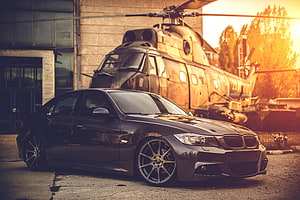 Black BMW E90 Sedan with Deep Concave Wheels Parked in Front of a Military Helicopter HD wallpaper