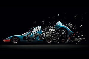 Ford GT40 Exploded View: Disintegrating Race Car with Scattering Components on Black Background HD wallpaper