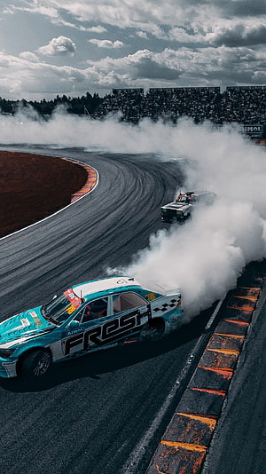 Two Race Cars Drifting Through a Corner on a Professional Circuit HD phone wallpaper
