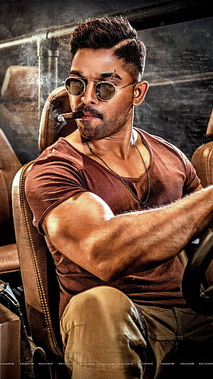 Allu Arjun in a rugged brown t-shirt and aviator sunglasses, smoking a cigar while seated in a car HD phone wallpaper