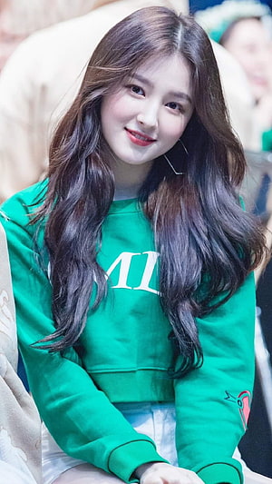 Nancy from Momoland in a green sweatshirt with long wavy hair HD phone wallpaper