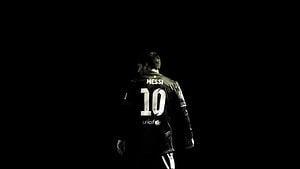 Lionel Messi in Barcelona Kit Walking Away in Dramatic Black and White Lighting HD wallpaper
