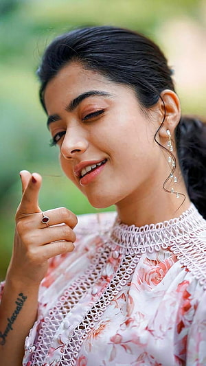 Rashmika Mandanna in a floral lace top with dangling earrings and a red gemstone ring HD phone wallpaper