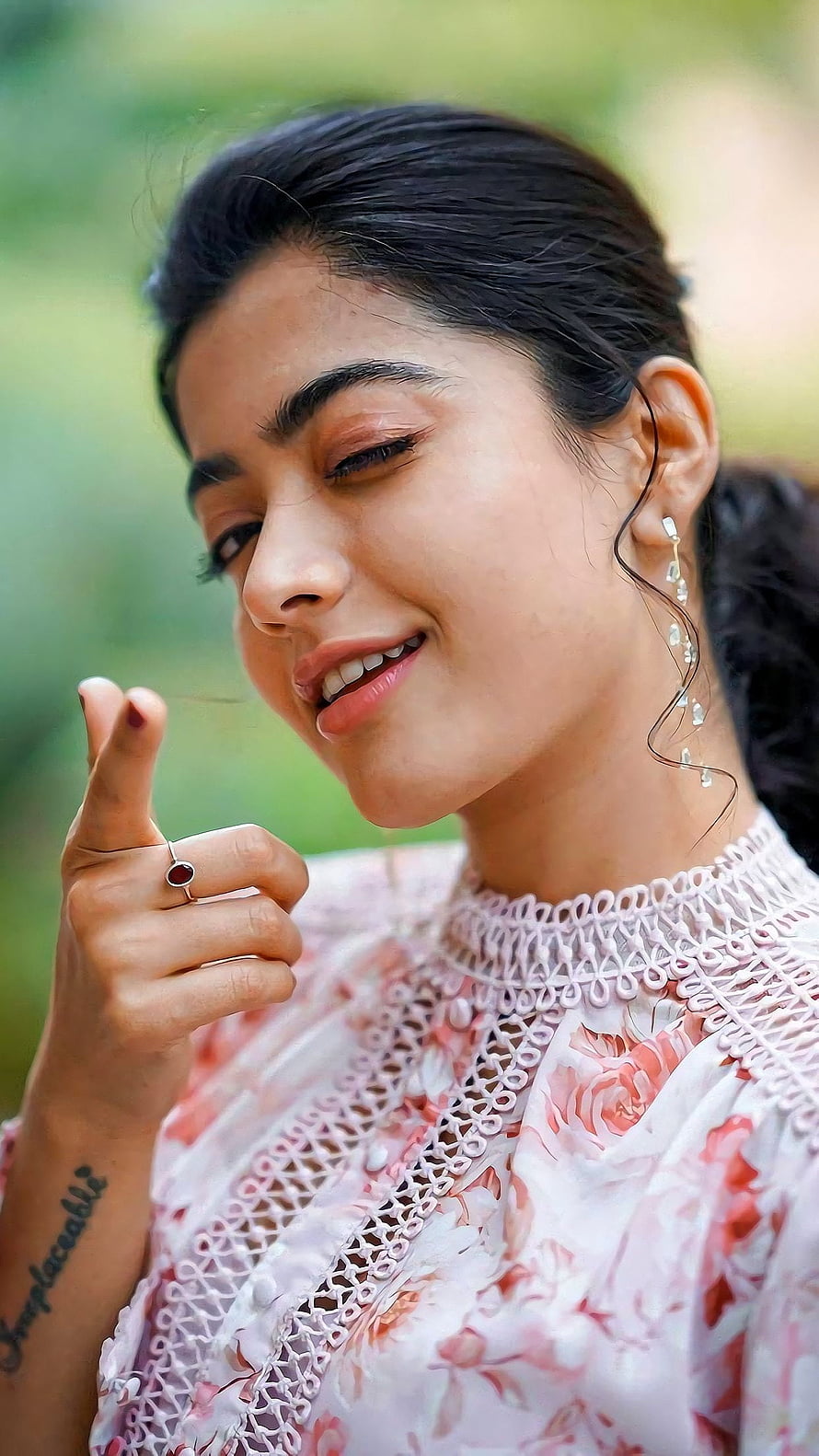 Rashmika Mandanna in a floral lace top with dangling earrings and a red gemstone ring HD phone wallpaper