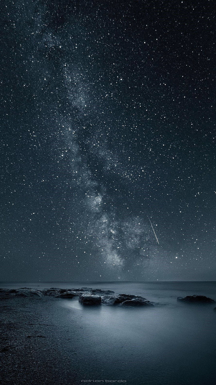 Milky Way Galaxy Over a Misty Rocky Shoreline at Night HD phone wallpaper