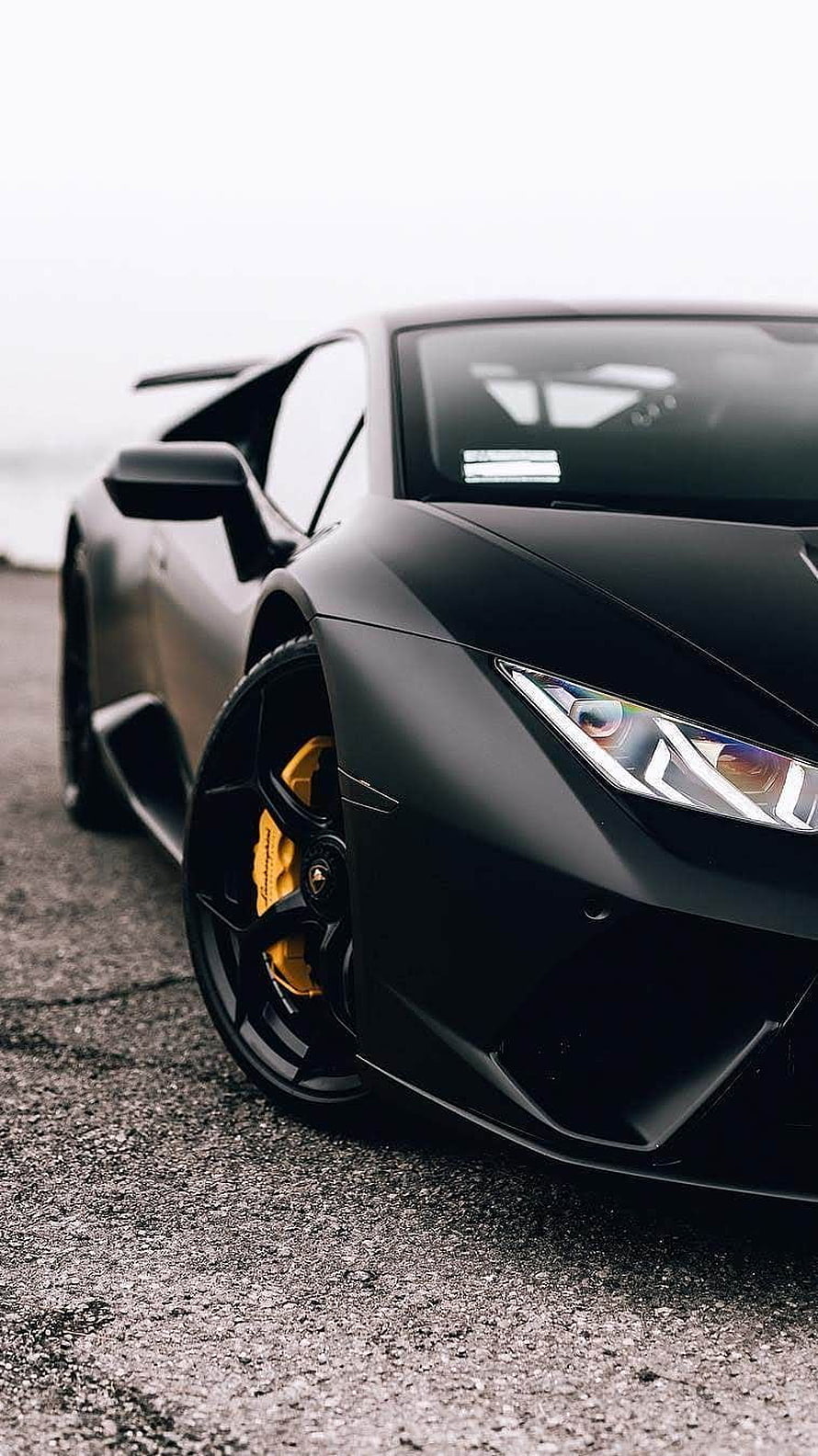 Matte Black Lamborghini Huracan Close-Up with Yellow Brakes and Aggressive Front Fascia HD phone wallpaper