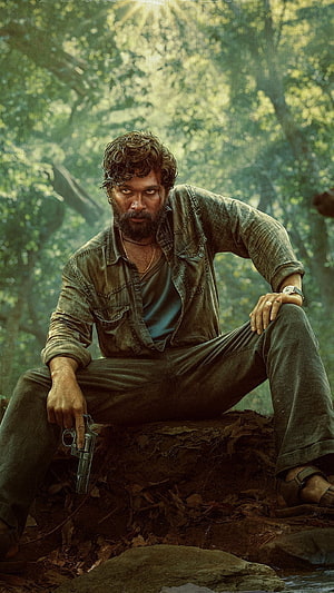 Allu Arjun as Pushpa in a gritty forest scene holding a revolver HD phone wallpaper