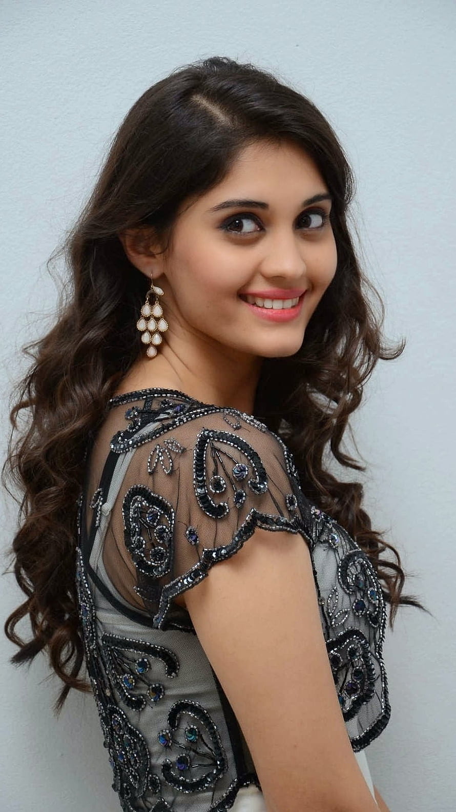 Surabhi Puranik in an elegant black embroidered sheer blouse with pearl drop earrings HD phone wallpaper