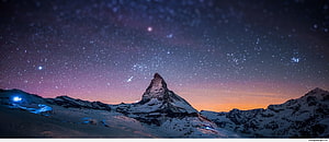 Matterhorn Peak Under a Starry Night Sky with Aurora and Snowy Alpine Landscape HD wallpaper