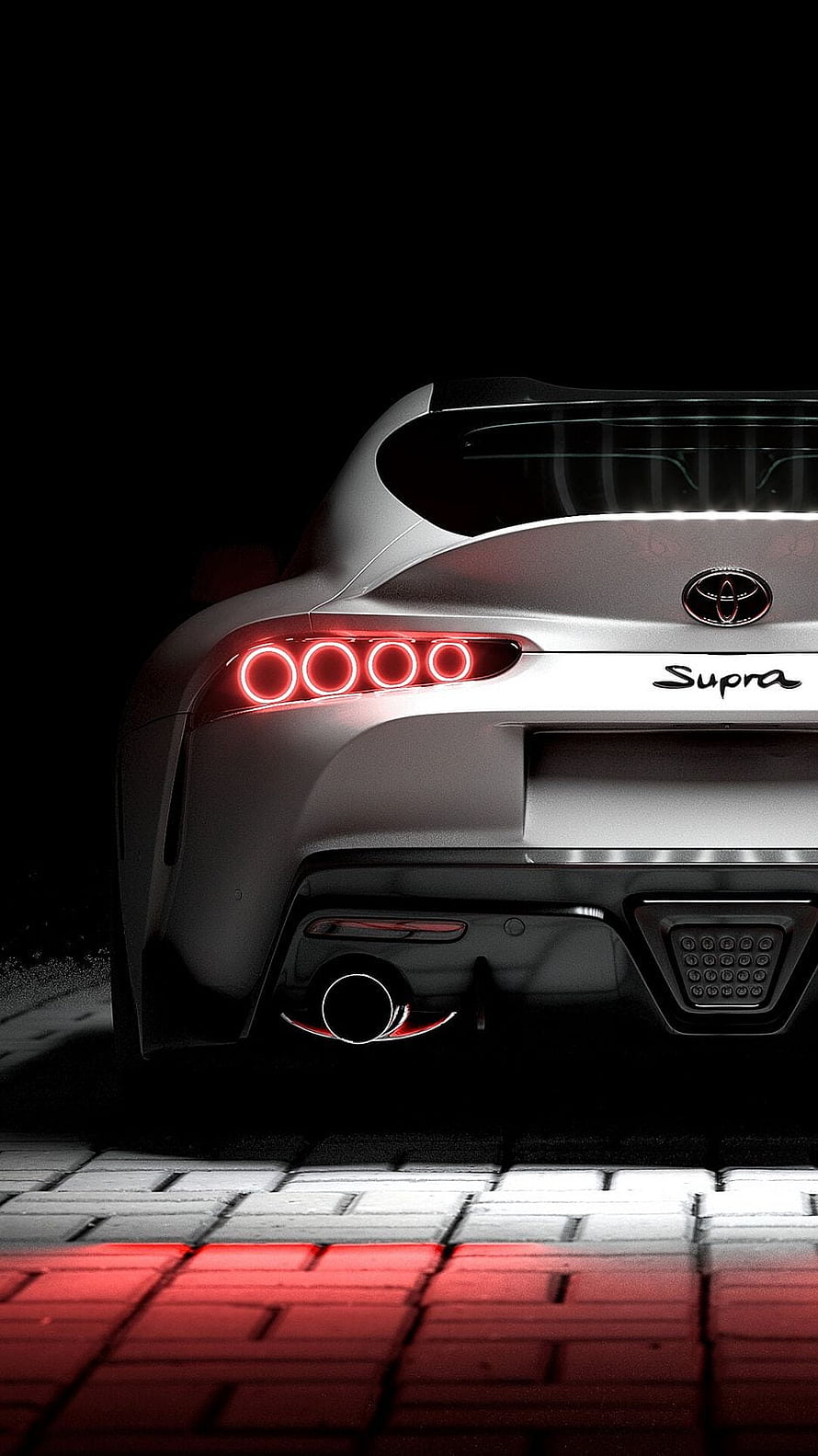 Rear View of a White Toyota Supra with Glowing Red Taillights on a Brick Road at Night HD phone wallpaper