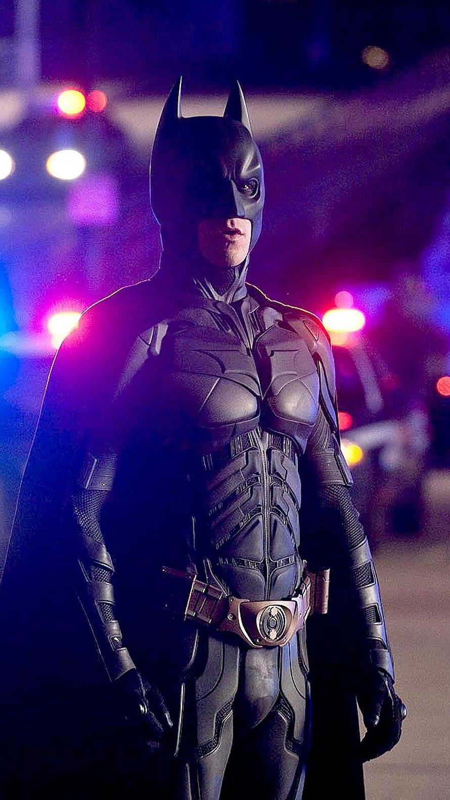 Christian Bale as Batman in The Dark Knight armored suit with neon city lights HD phone wallpaper