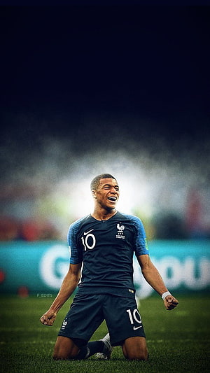 Kylian Mbappe Celebrating in France National Team Kit on the Soccer Pitch HD phone wallpaper