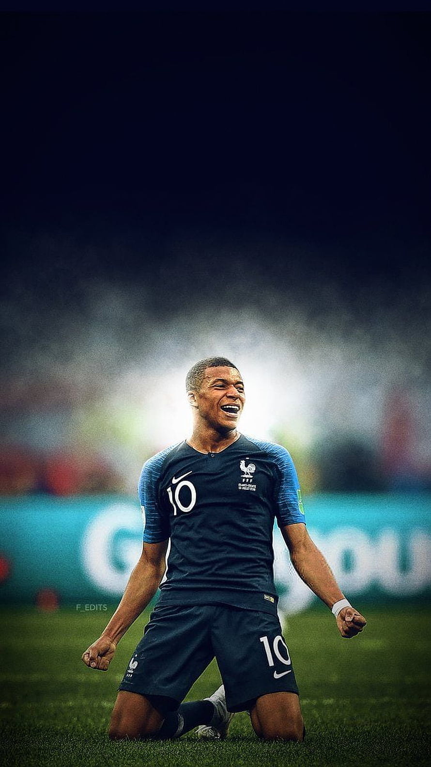Kylian Mbappe Celebrating in France National Team Kit on the Soccer Pitch HD phone wallpaper