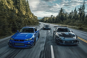 Nissan GT-R and Nissan Skyline GT-R Racing on a Forest Road HD wallpaper
