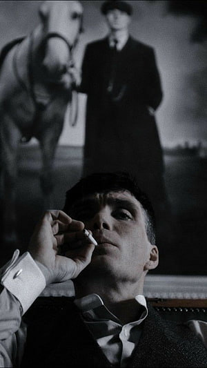 Tommy Shelby from Peaky Blinders Smoking a Cigarette in a Dimly Lit Room HD phone wallpaper
