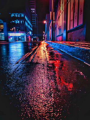 Moody Urban Street at Night with Wet Asphalt and Neon Light Reflections HD phone wallpaper