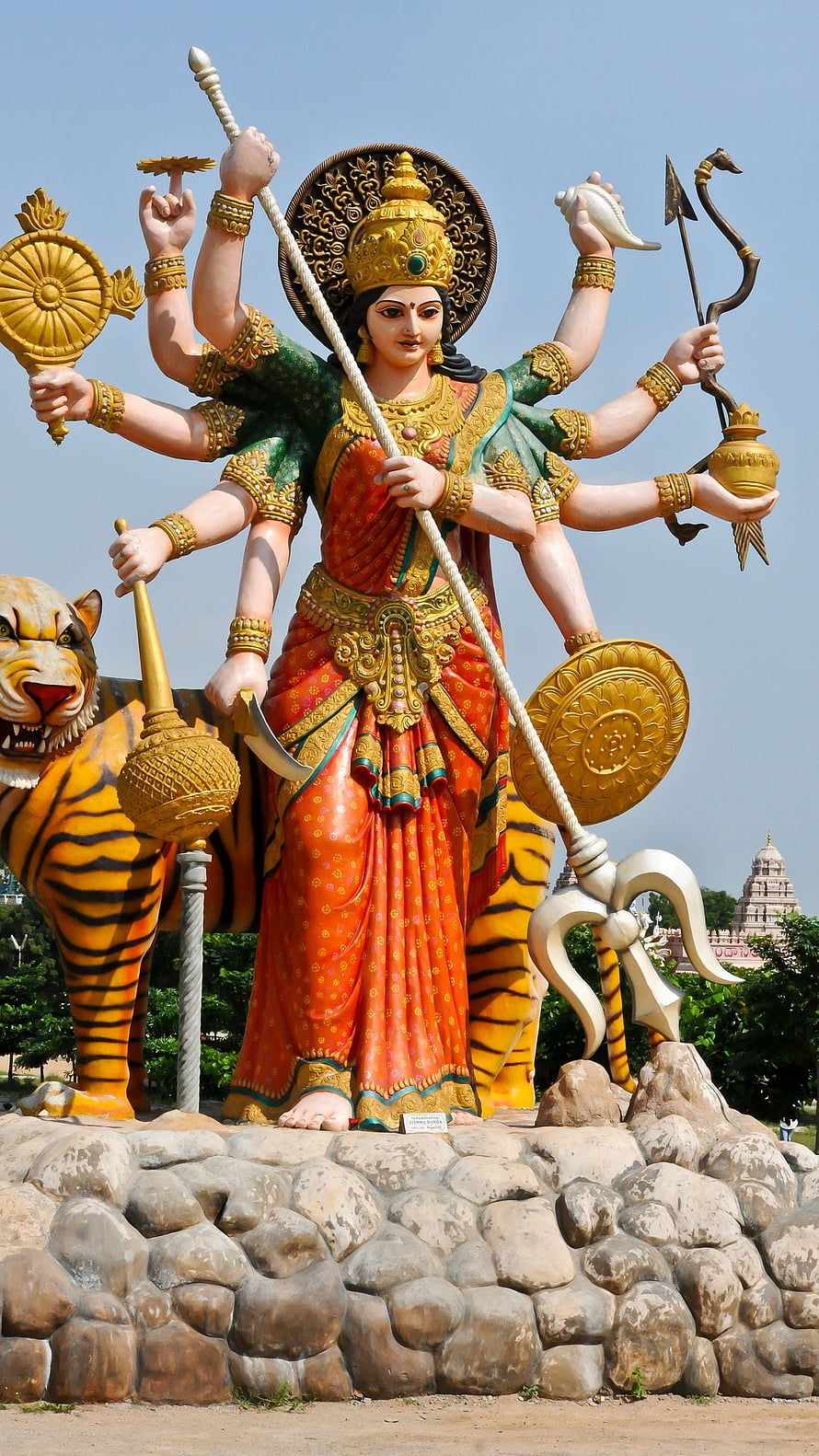 Giant Multi-Armed Goddess Durga Statue with Tiger and Traditional Weapons HD phone wallpaper