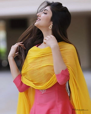 Sreeleela in a vibrant pink kurta and flowing yellow dupatta with long dark hair HD phone wallpaper