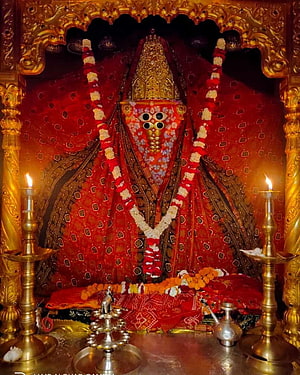 Ashapura Maa Temple Deity Adorned in Red Silk and Gold with Flower Garlands and Brass Lamps HD phone wallpaper