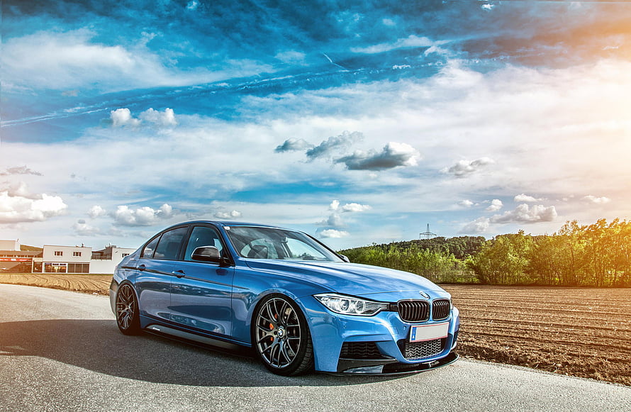 Blue BMW F30 Sedan with Stance Setup on Rural Road Under Dramatic Sky HD wallpaper