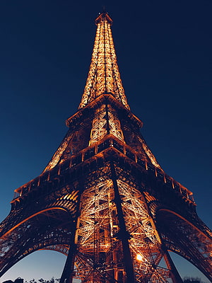 Eiffel Tower Illuminated at Night Against a Deep Blue Sky in Paris HD phone wallpaper