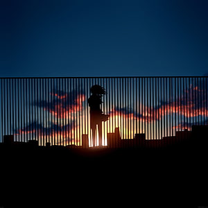 Silhouette of a Girl Standing on a Rooftop Against a Vibrant Sunset Sky HD phone wallpaper
