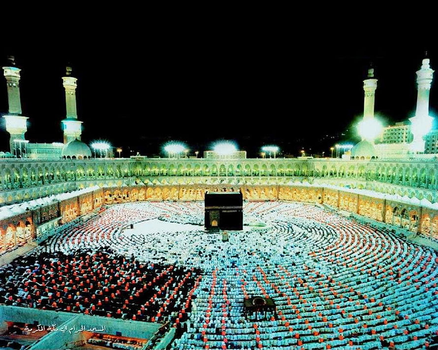 The Kaaba at Night in Mecca with Pilgrims in Prayer Circles HD wallpaper