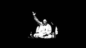 Nusrat Fateh Ali Khan performing live on stage in dramatic black and white HD wallpaper