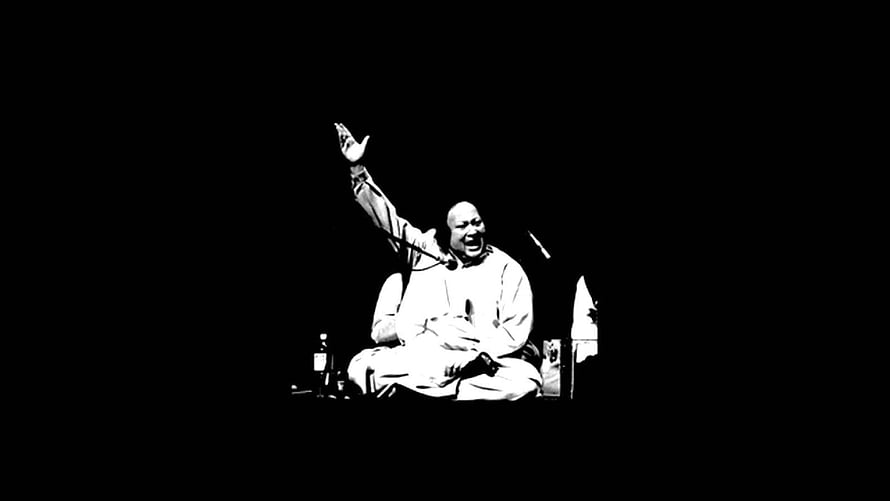 Nusrat Fateh Ali Khan performing live on stage in dramatic black and white HD wallpaper