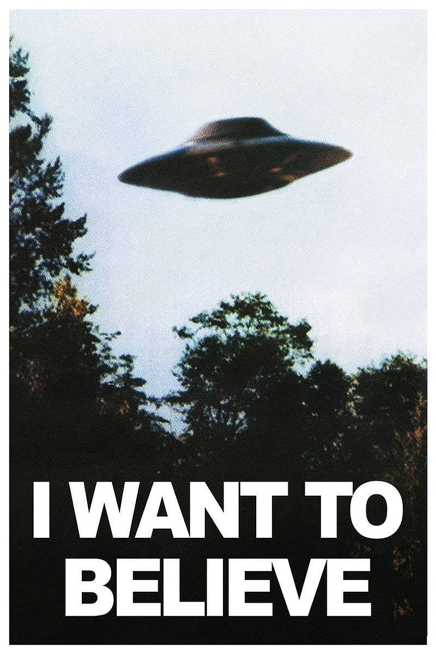 Classic I Want To Believe UFO Poster with Silhouetted Trees and Mysterious Flying Saucer HD phone wallpaper