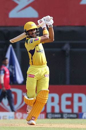 Ruturaj Gaikwad in yellow Chennai Super Kings kit mid-swing during a T20 cricket match HD phone wallpaper