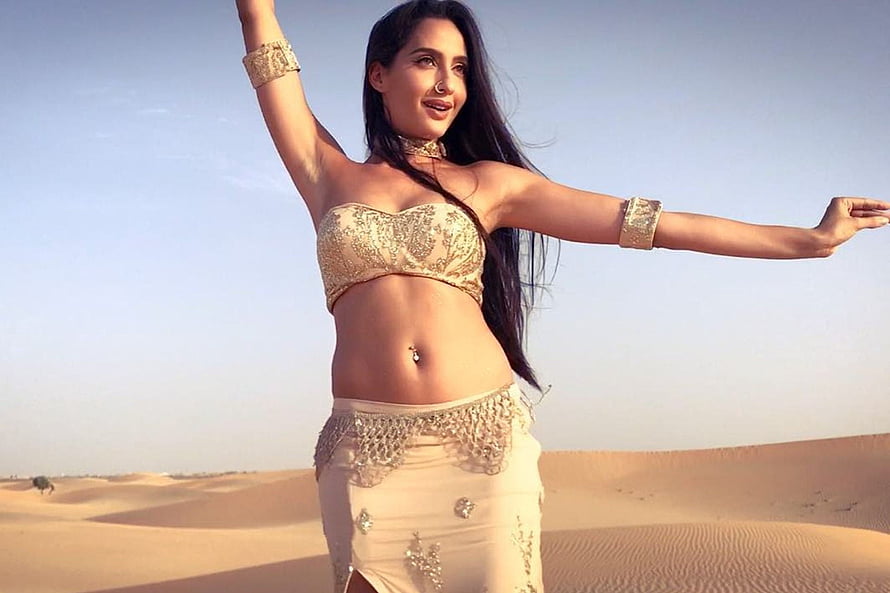 Nora Fatehi in Gold Belly Dance Costume Against Desert Dunes HD wallpaper
